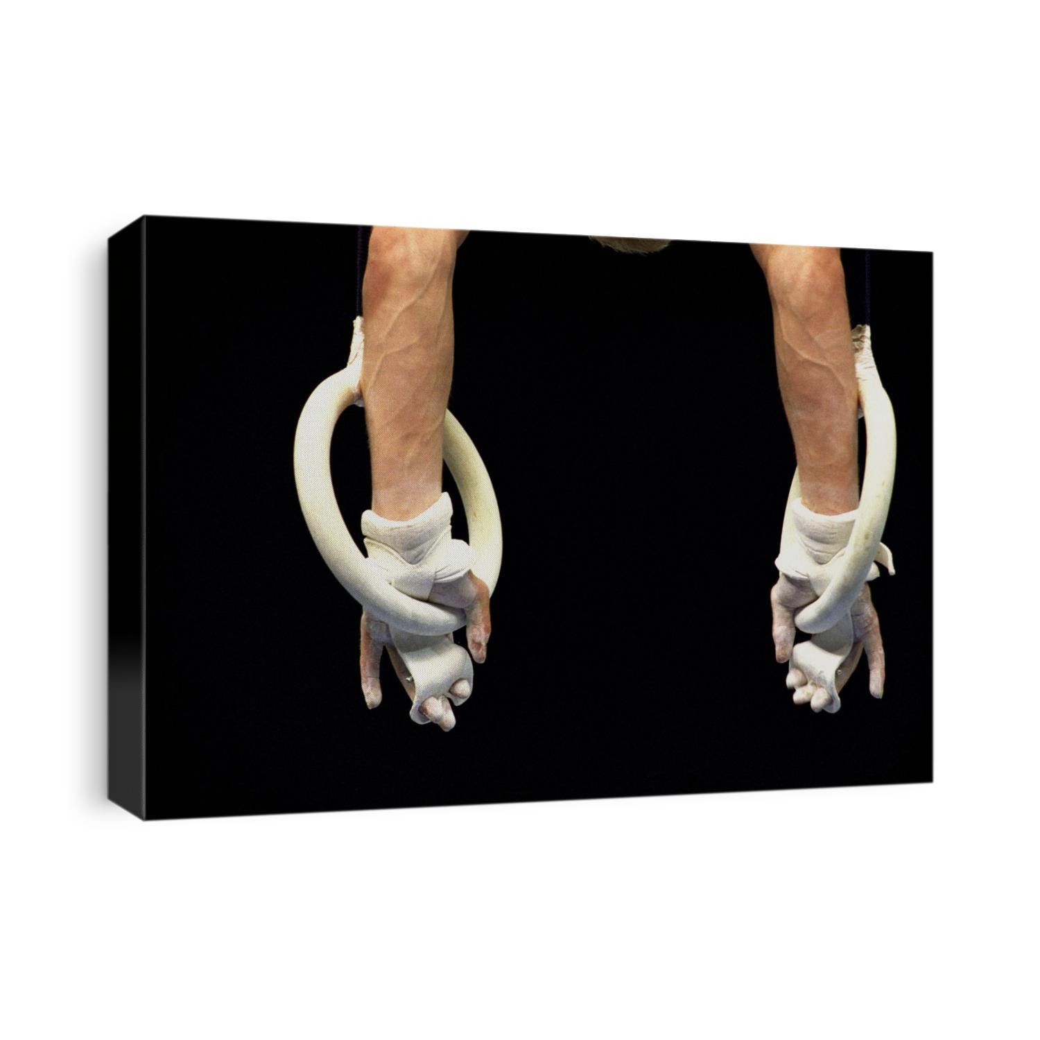 Detail of male gymnasts hands on the rings.