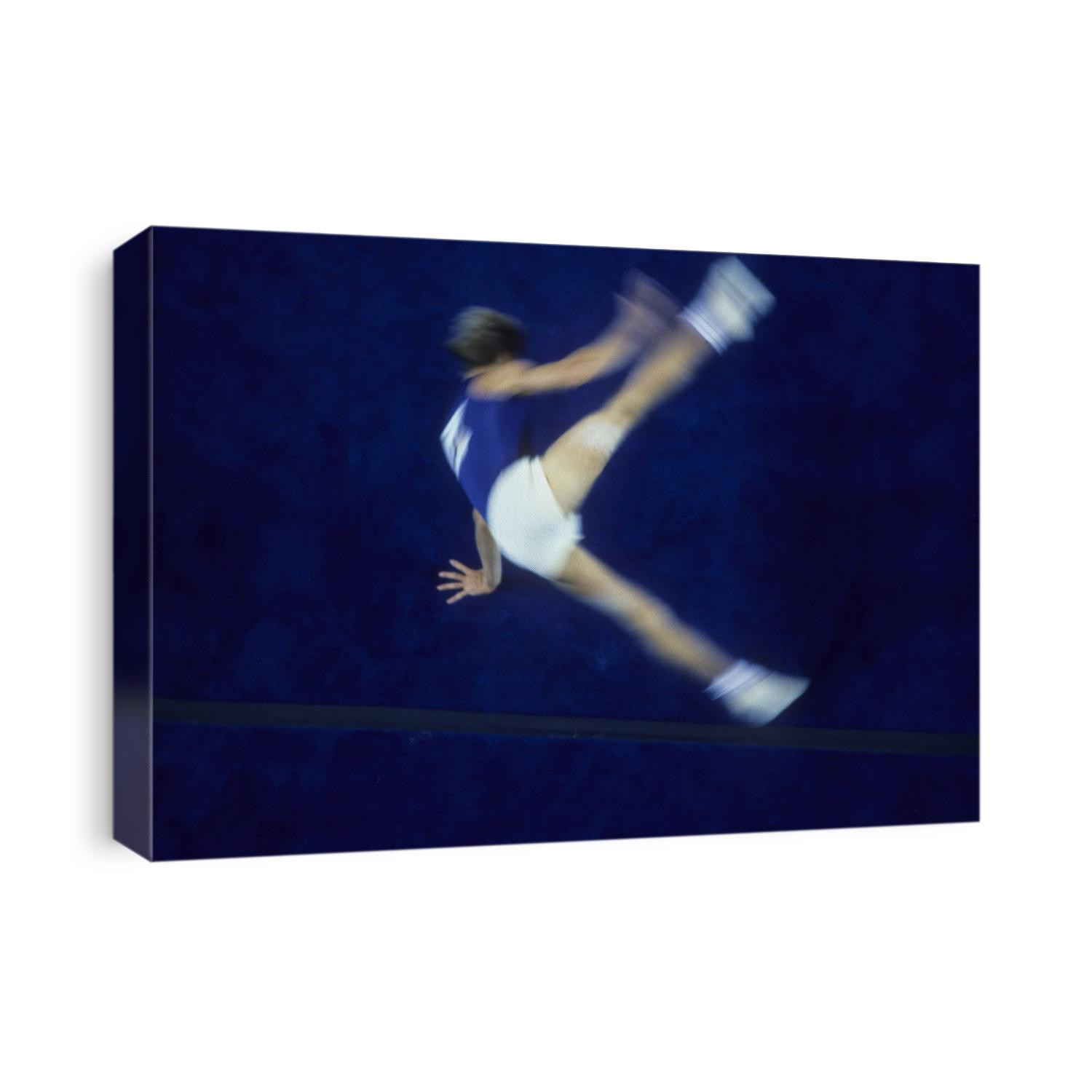 Blurred action of male gymnast on the floor exercise.