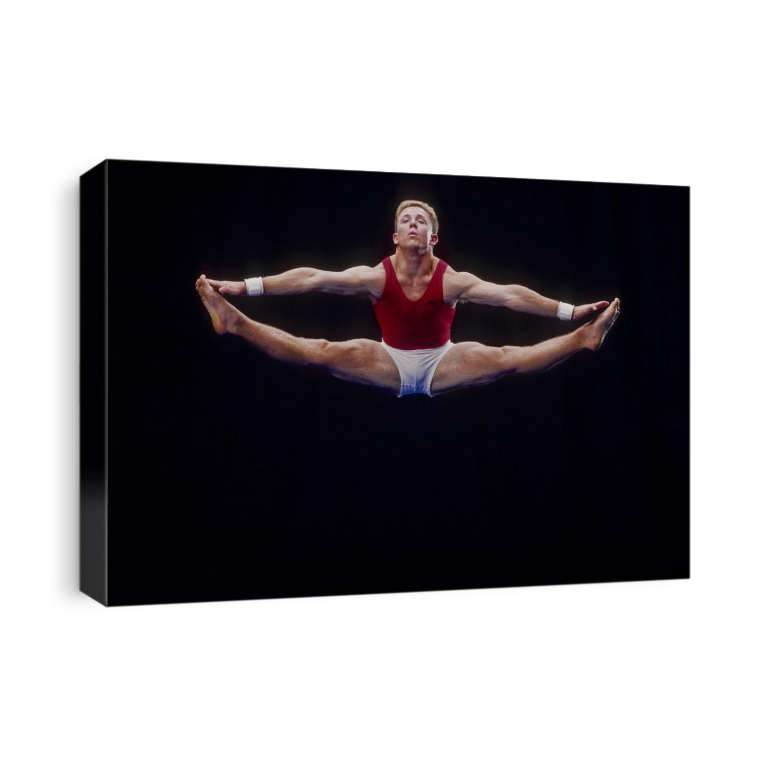 Male gymnast performing on the floor exercises.