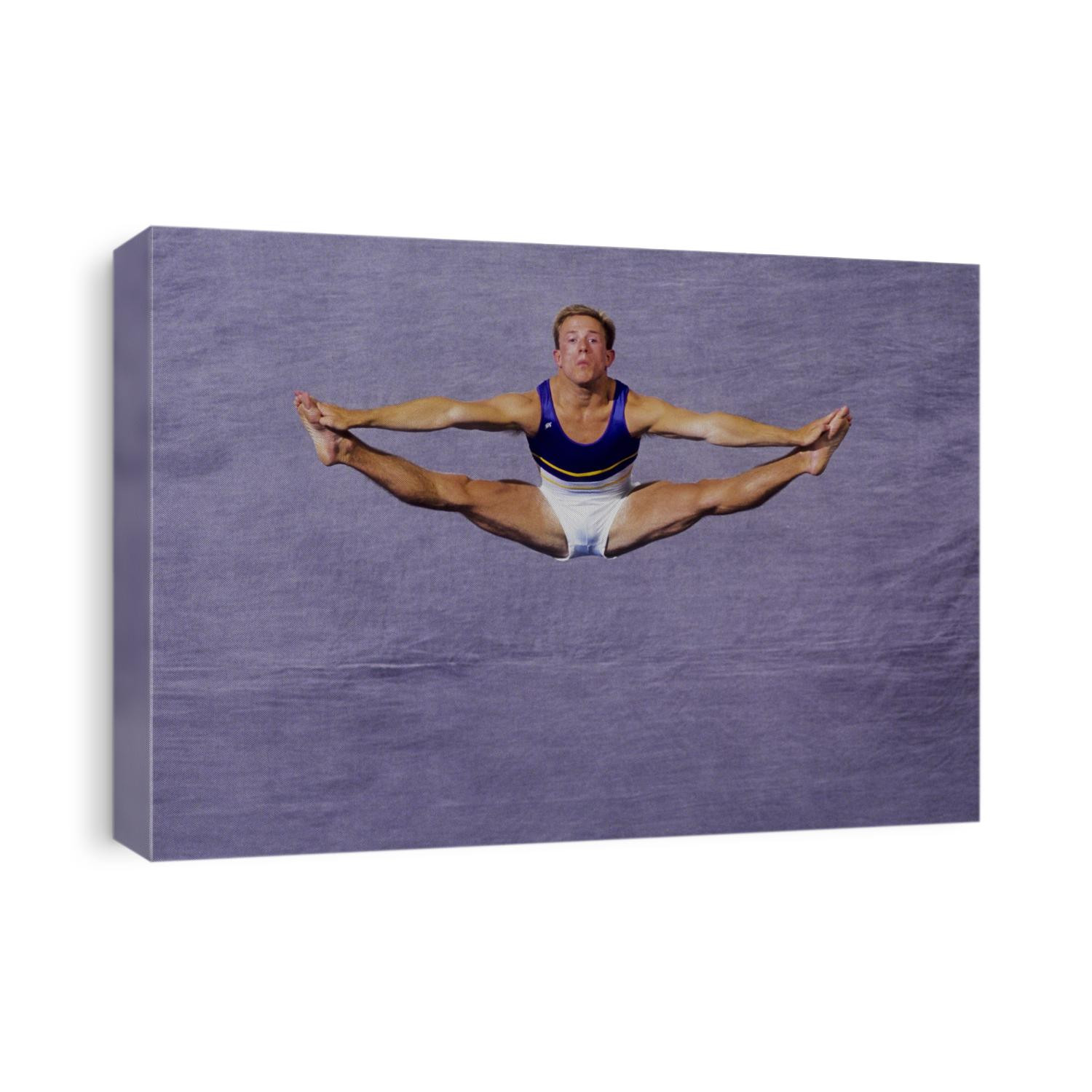 Male gymnast performing on the floor exercises.