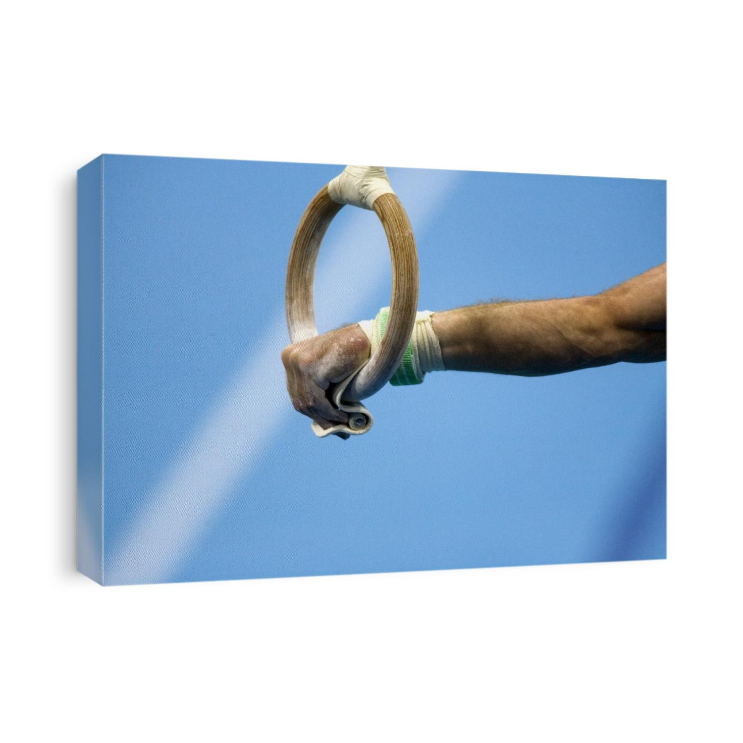 Detail of male gymnast competing on the rings