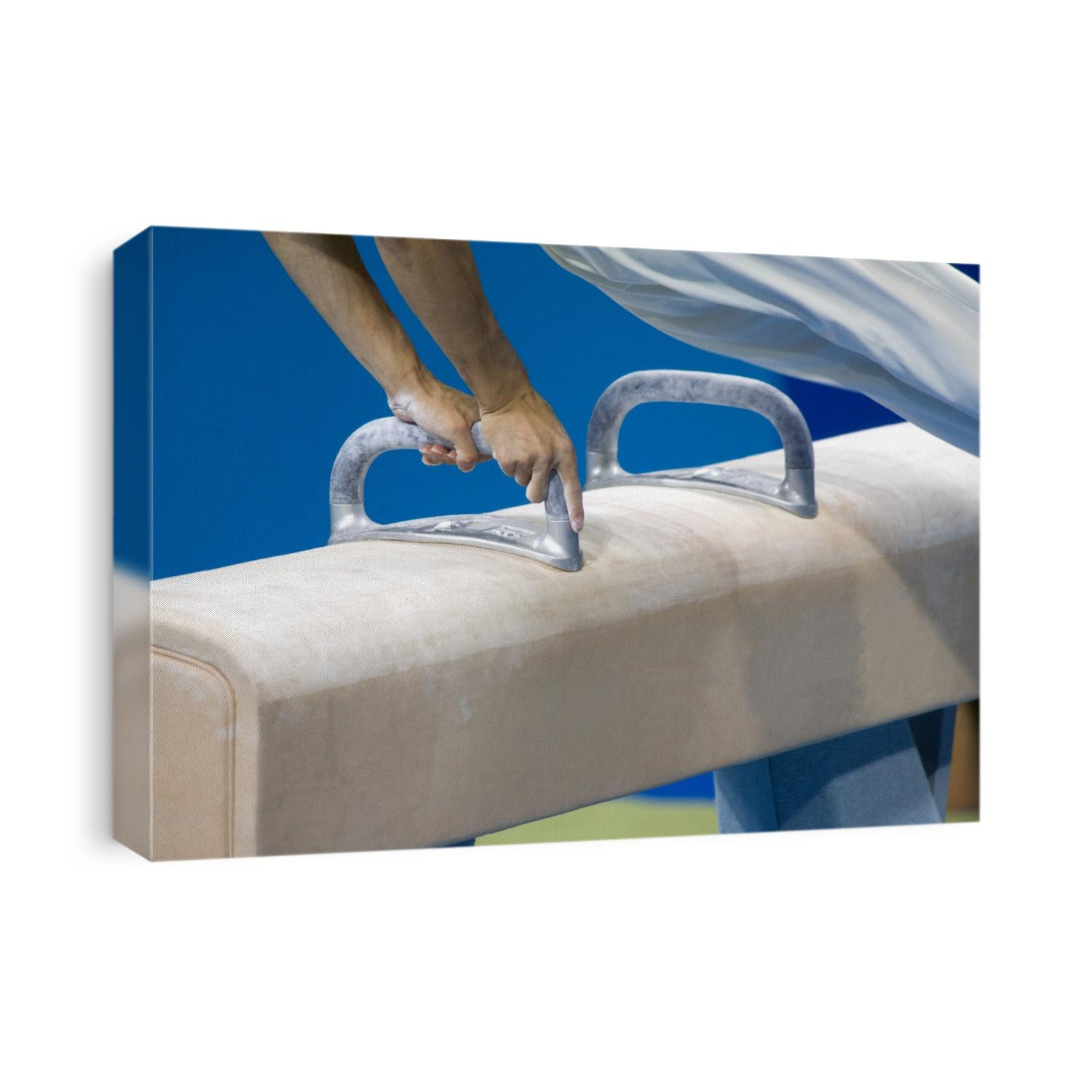 Detail of male gymnast competing on the pommel horse.