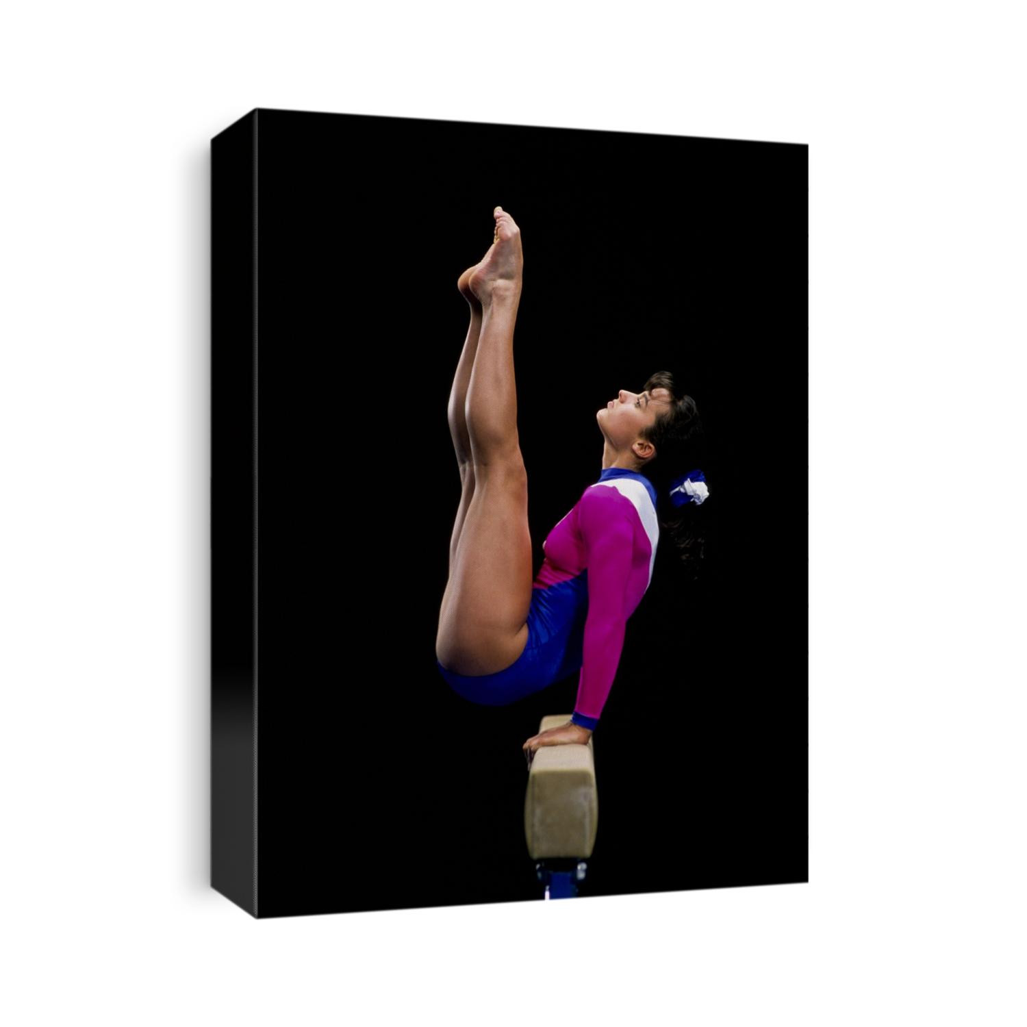 Female gymnast performing on the balance beam.