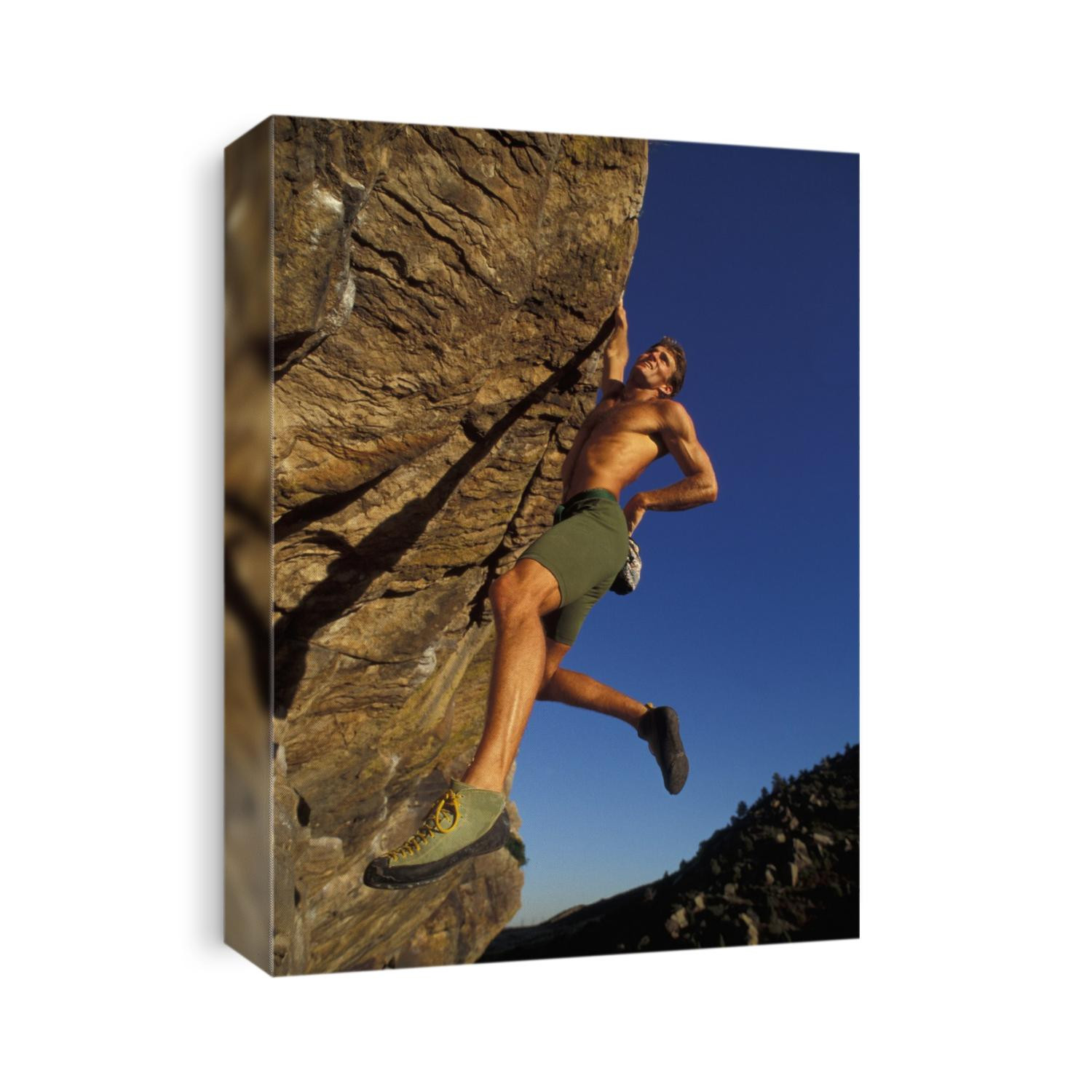 Rock climber hanging from grip.