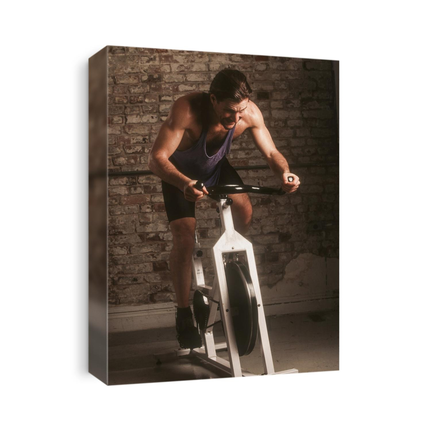 Adult male exercising on a stationary bike.