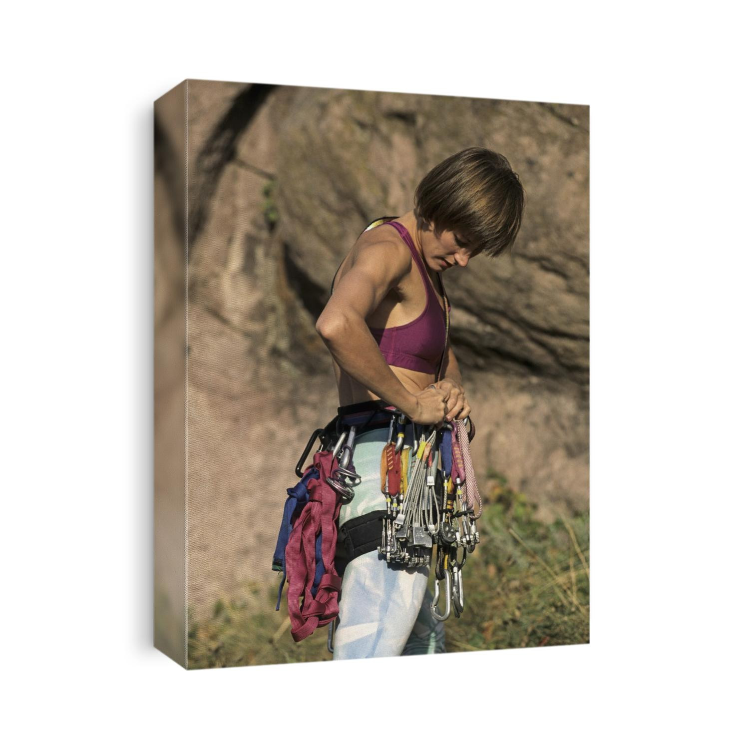 Female rock climber preparing her equipment.