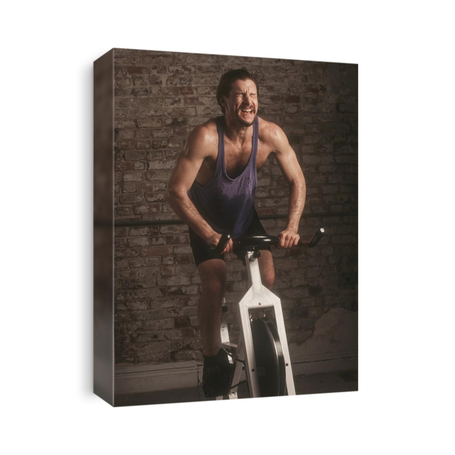 Adult male exercising on a stationary bike.