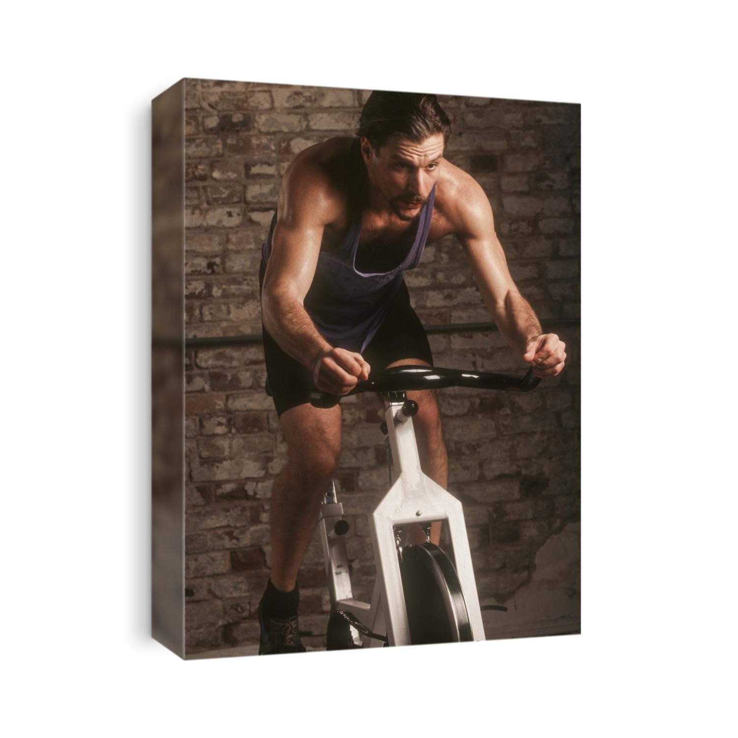 Adult male exercising on a stationary bike.