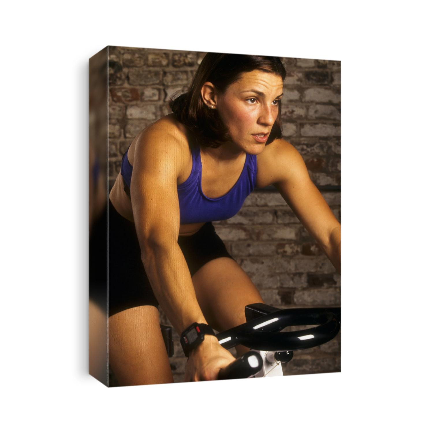 Young woman exercising on a stationary bike.