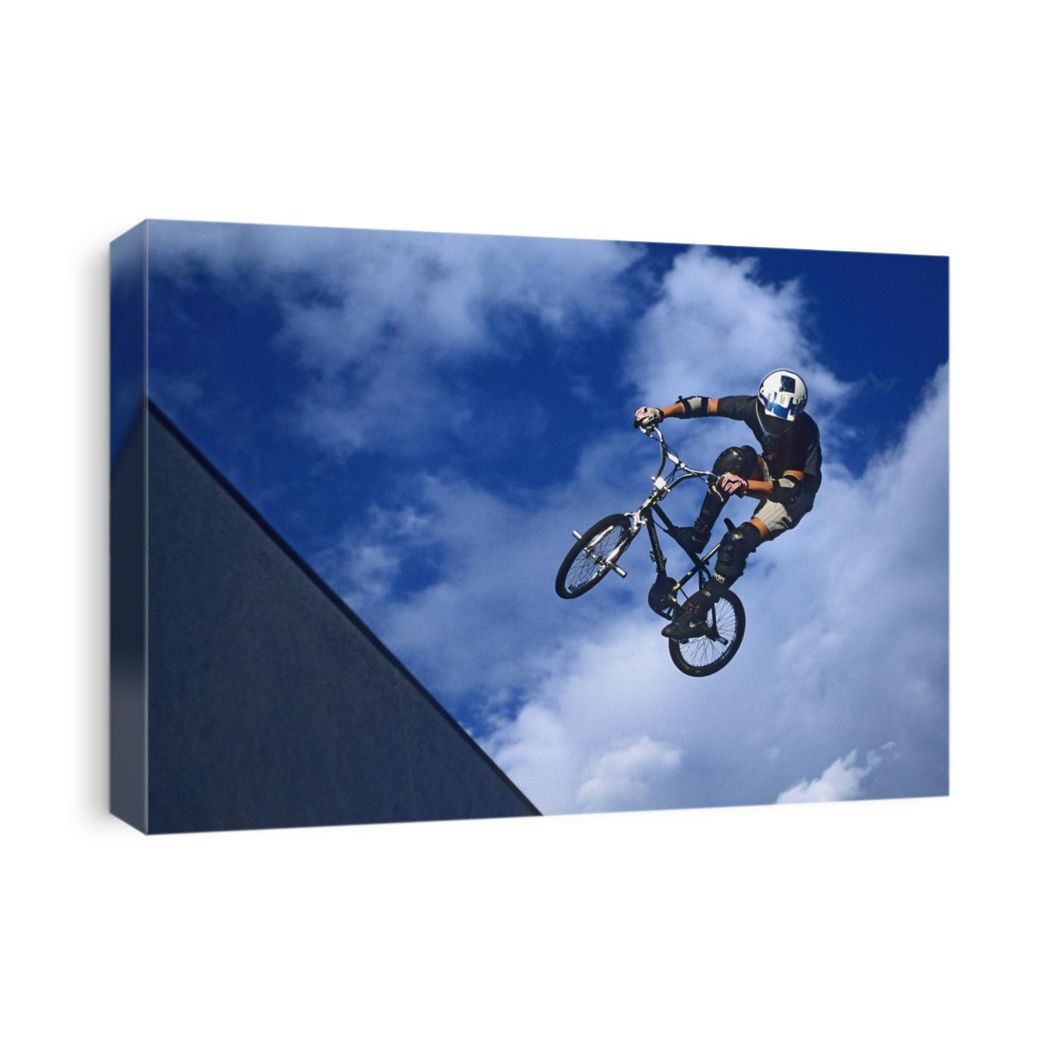 BMX cyclist flys over the vert.