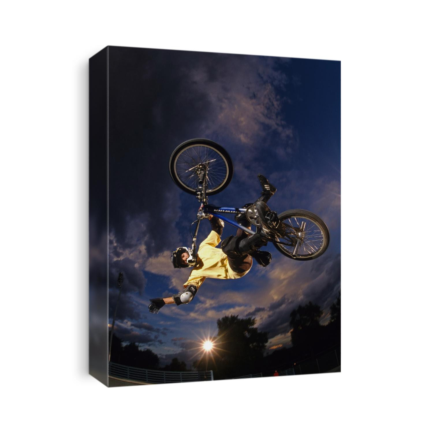 BMX cyclist flys over the vert.