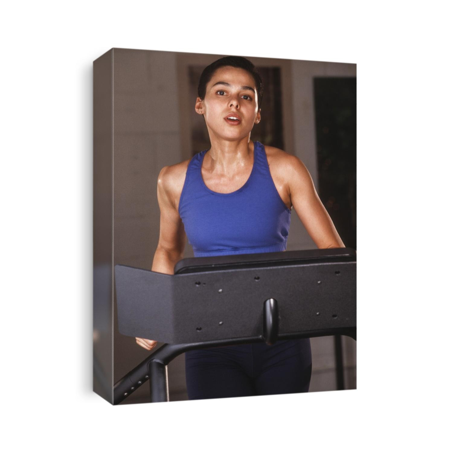 Woman exercising on a tredmill at a health club.