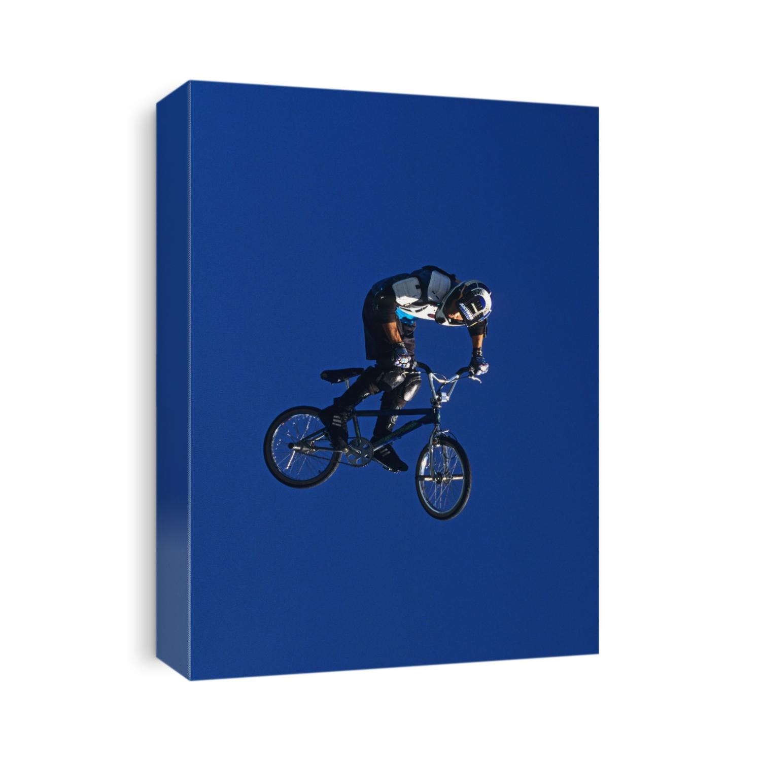 BMX cyclist flys over the vert.