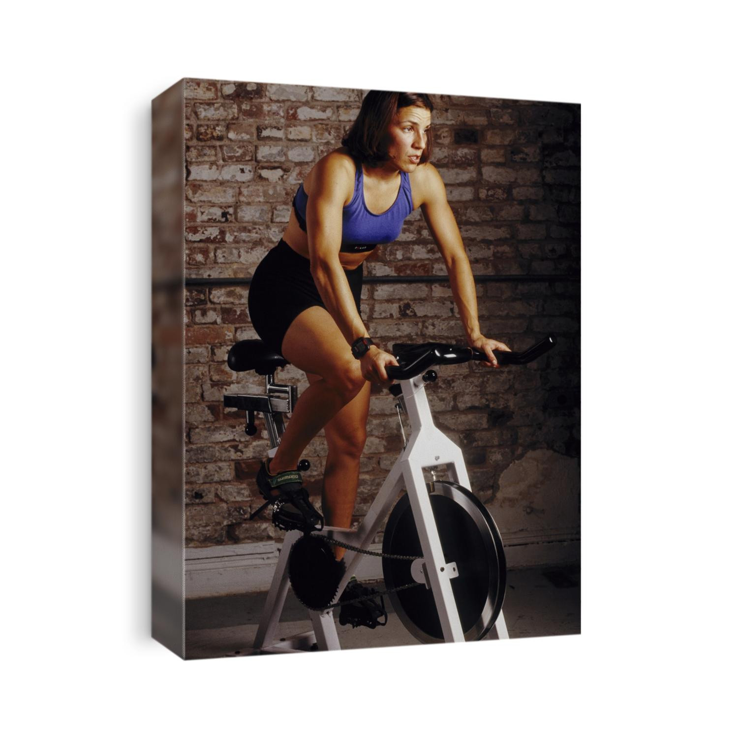Young woman exercising on a stationary bike.