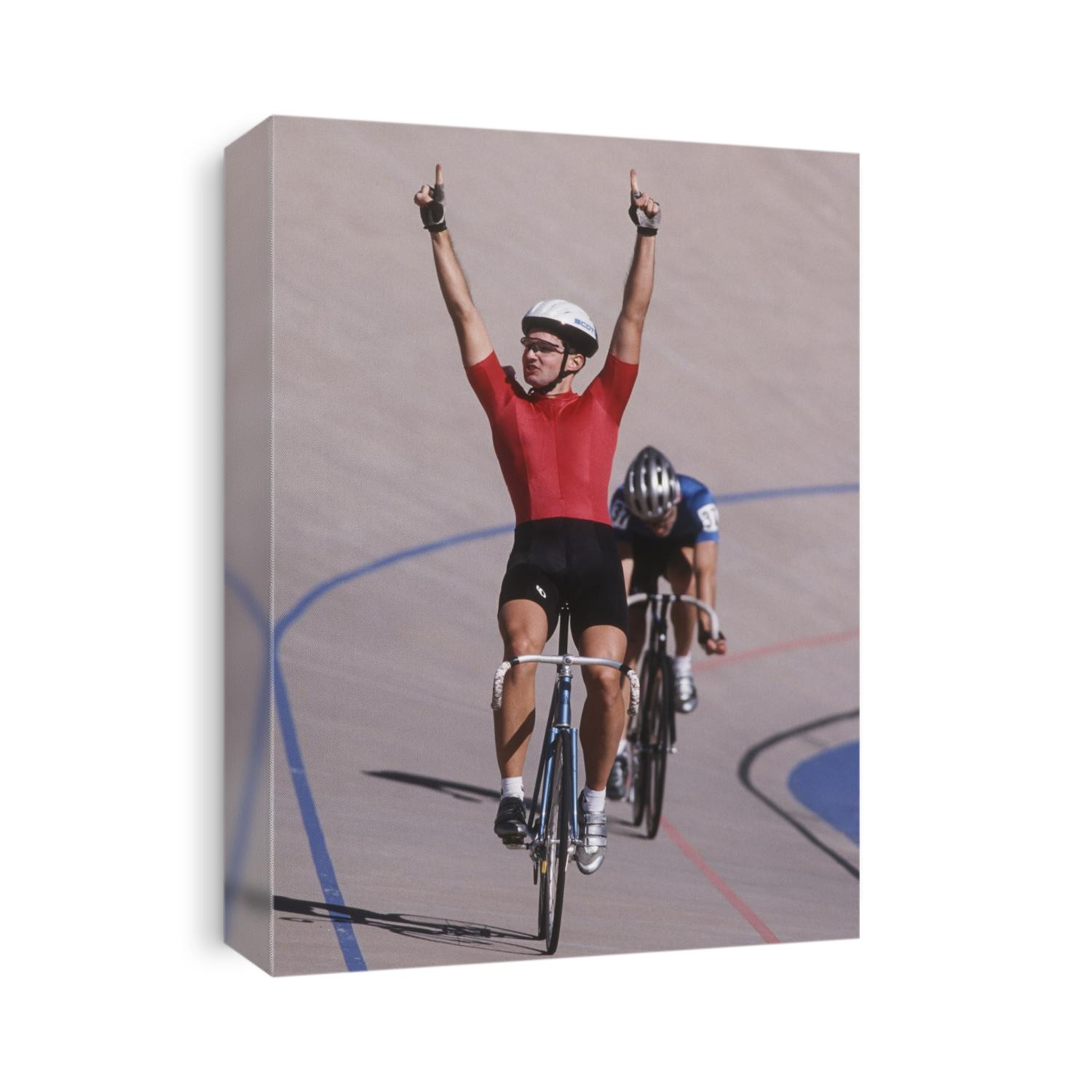 Male cyclist winning on the velodrome.