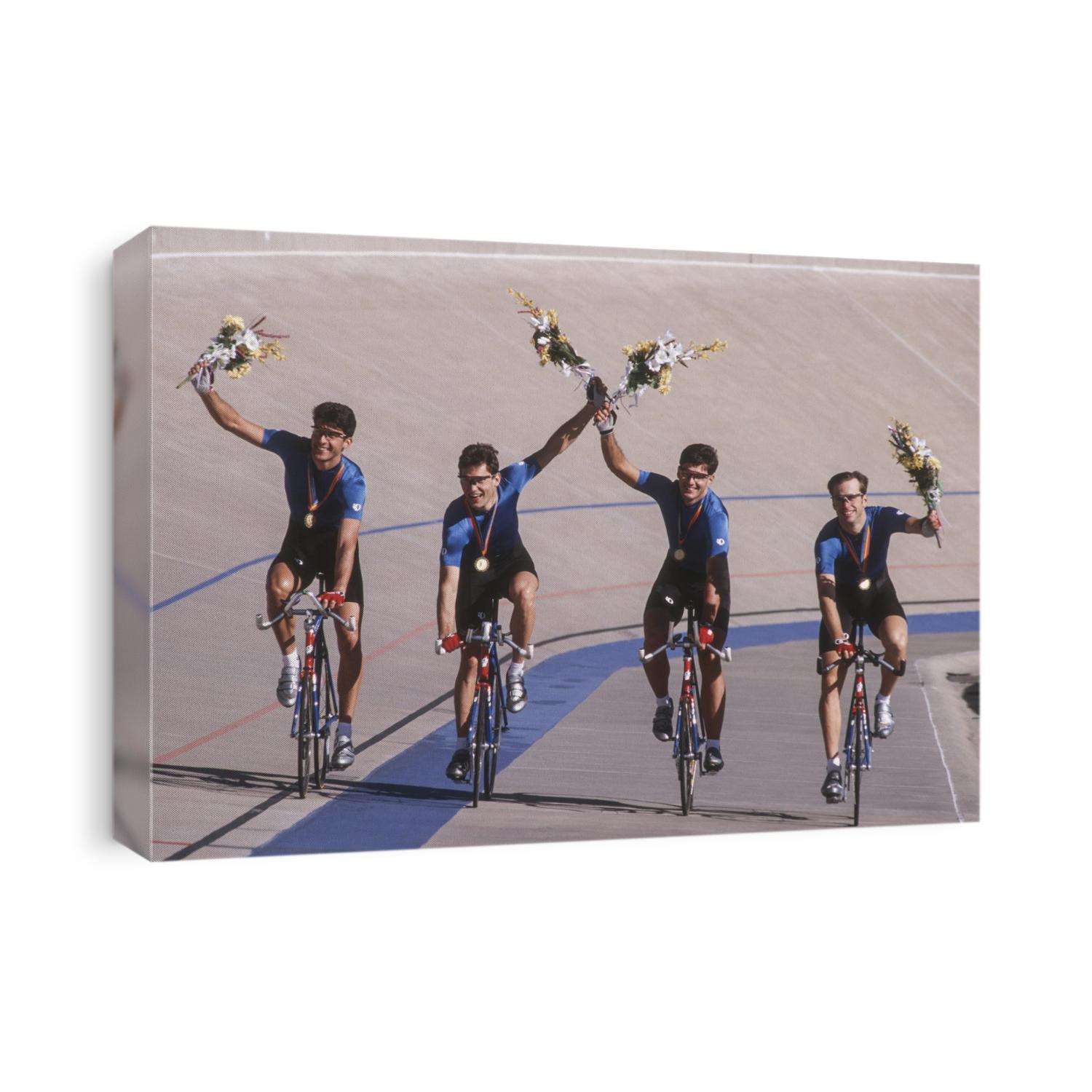 Victorious male cycling team on the velodrome.