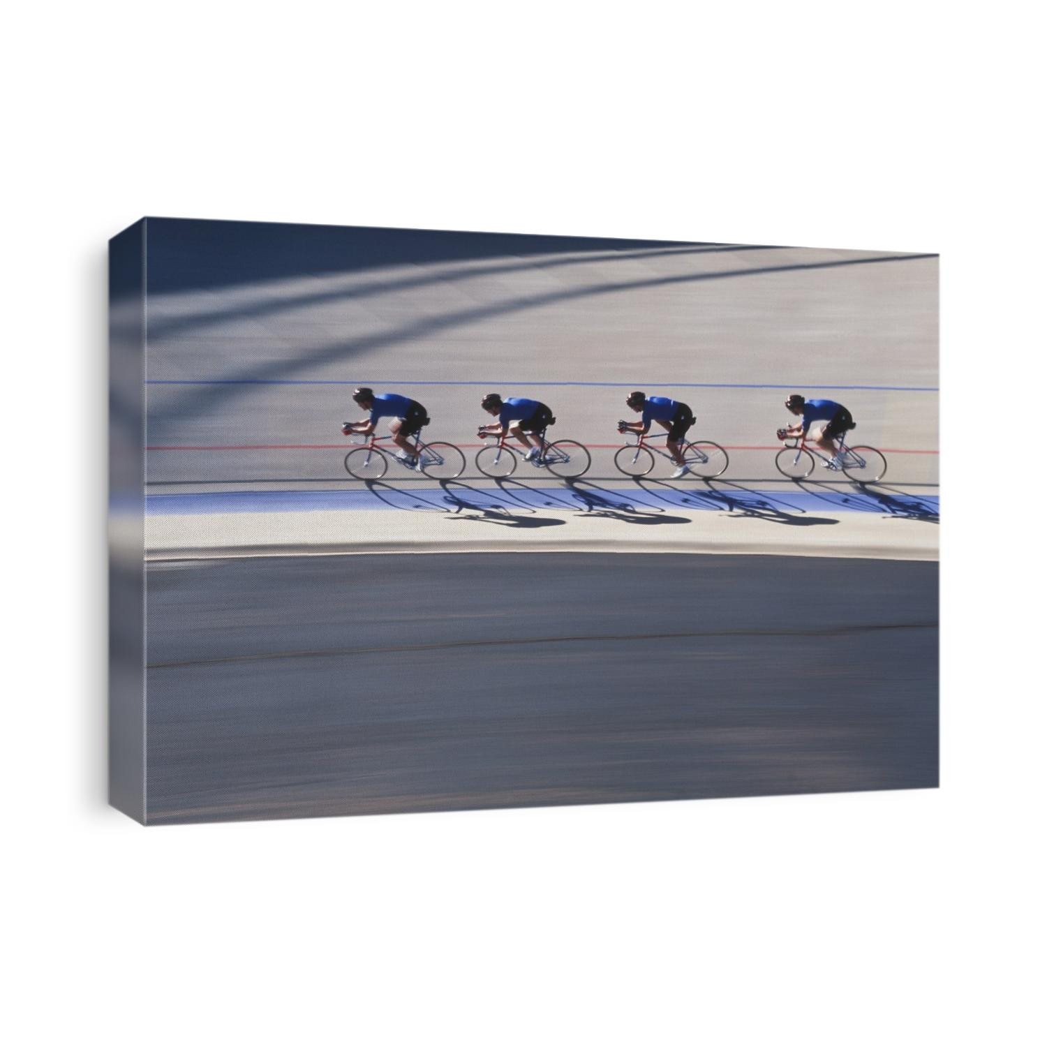 Male cycling team racing on the velodrome track.