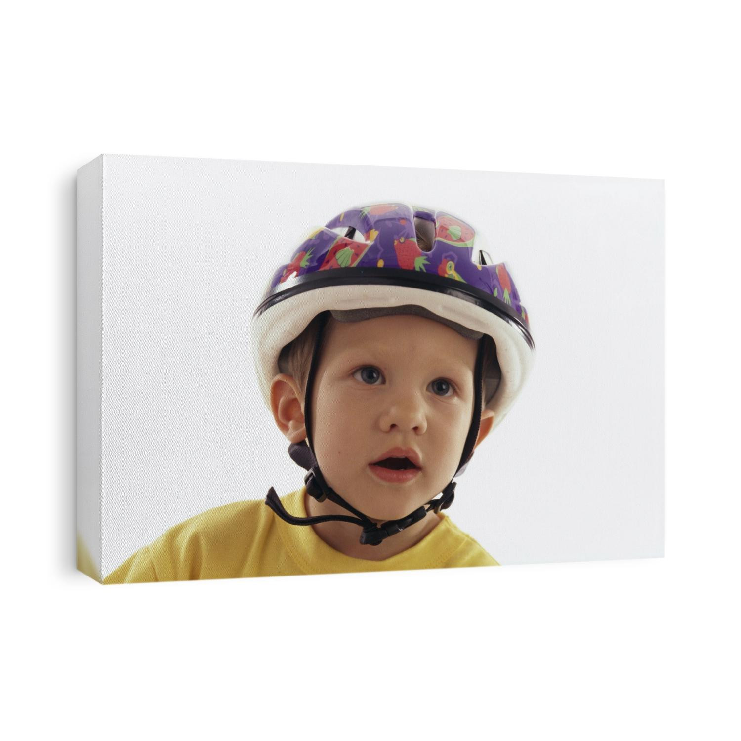 4 year old boy posing on his tricycle.
