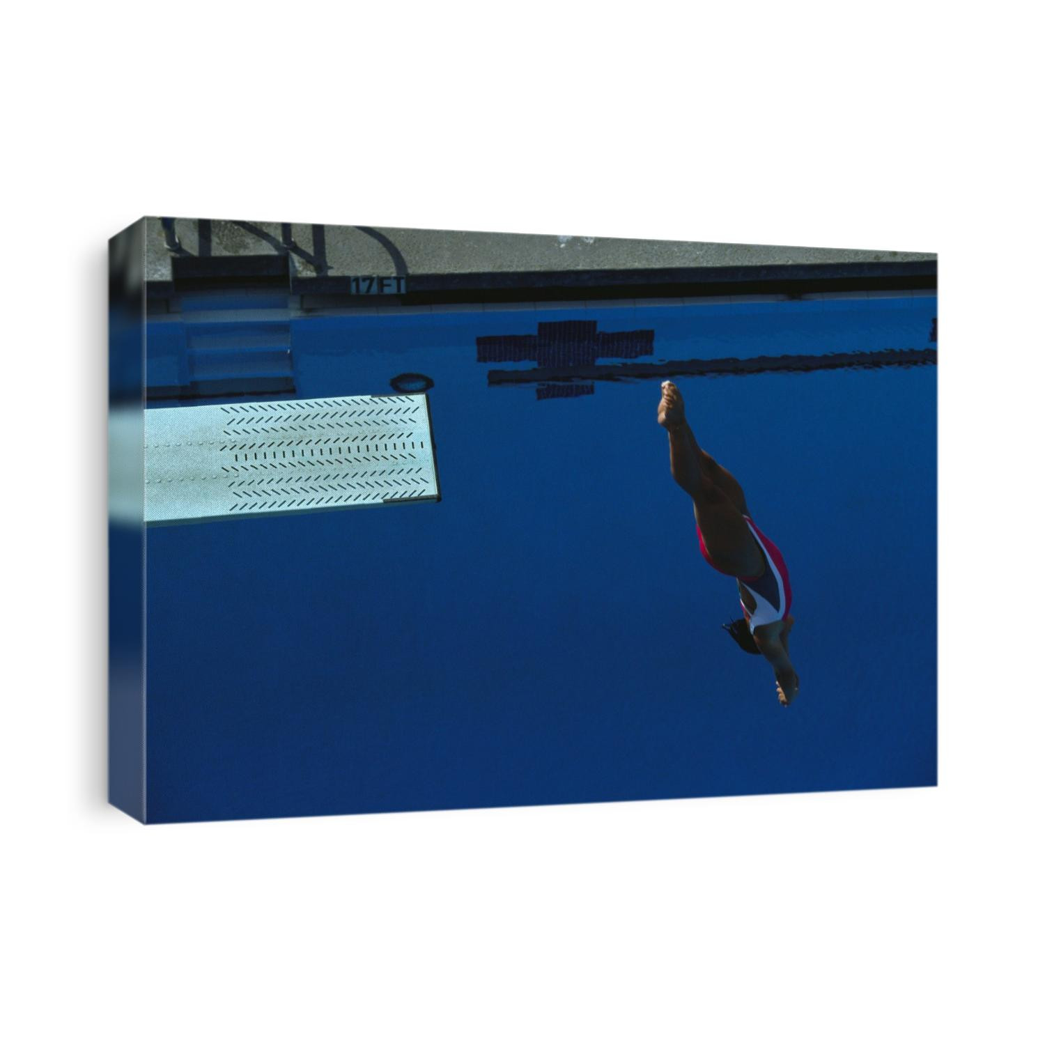 Woman diving off the springboard.