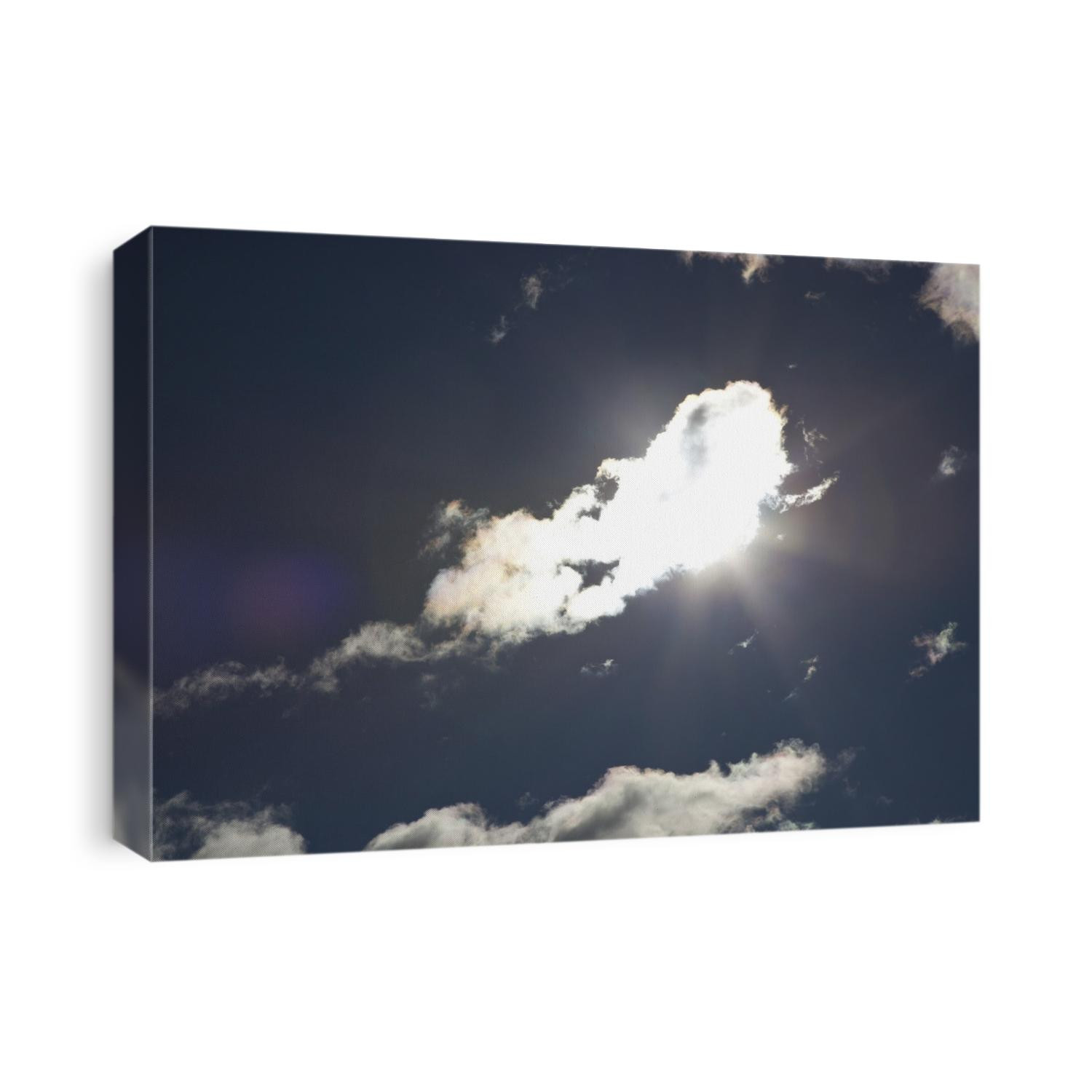 Sun in the sky behind cloud cover.