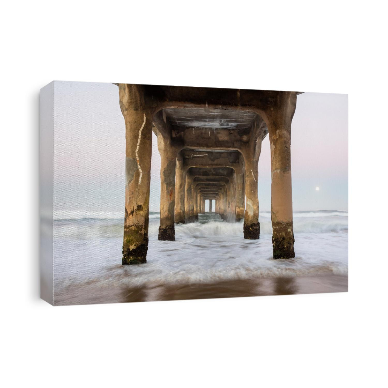 A full moon sets just beyond the iconic Manhattan Beach Pier