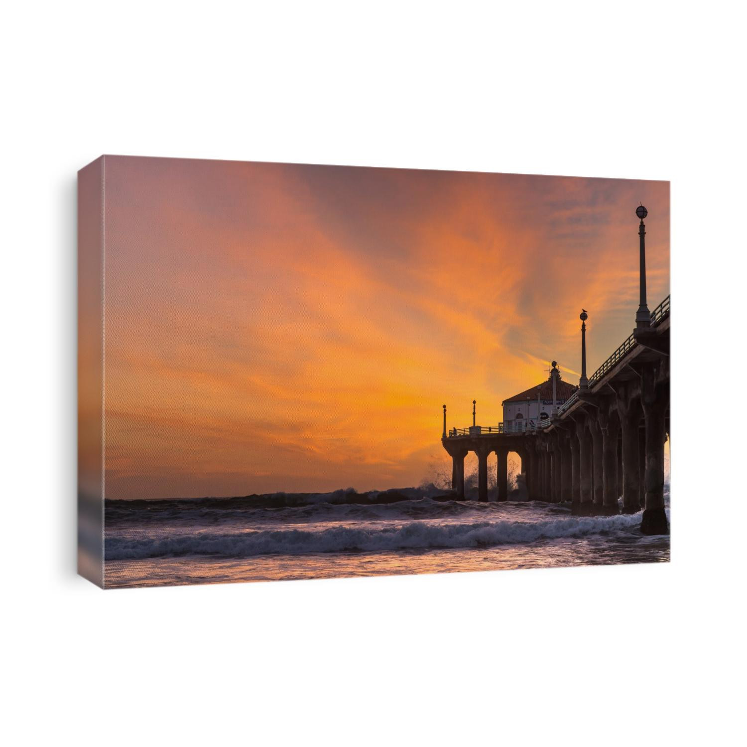 A winter swell breaks underneath the Manhattan Beach pier