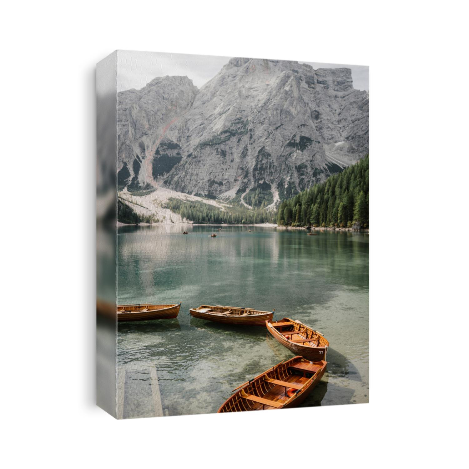 Natural landscapes of the mountain lake Braies in the Dolomites, Italy. Boats on the mountain lake Braies (Lake Pragser Wildsee) in Sudtirol. The mountains. Linked boats on a mountain lake