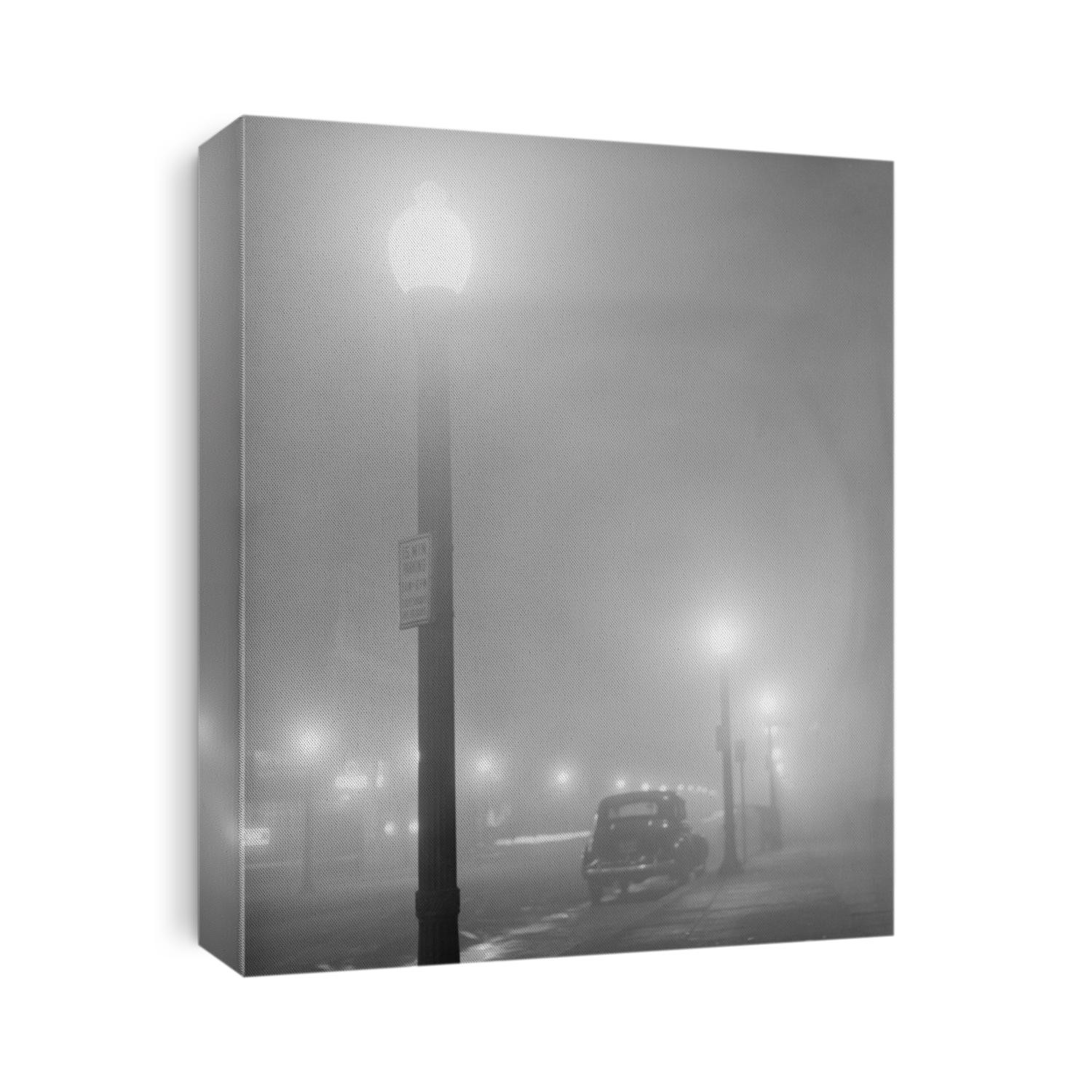 Street lights glow on a foggy night in New Bedford, Massachusetts, Jan. 1941.