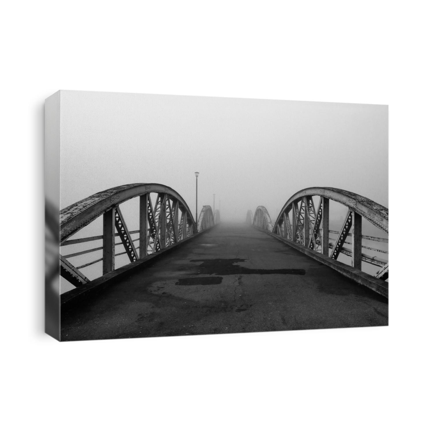 Bridge to nowhere. Black and white old steel bridge road. Monochrome artistic photography. Structure shilouette in foggy weather. Straight line themed image. Urban architecture outdoors.