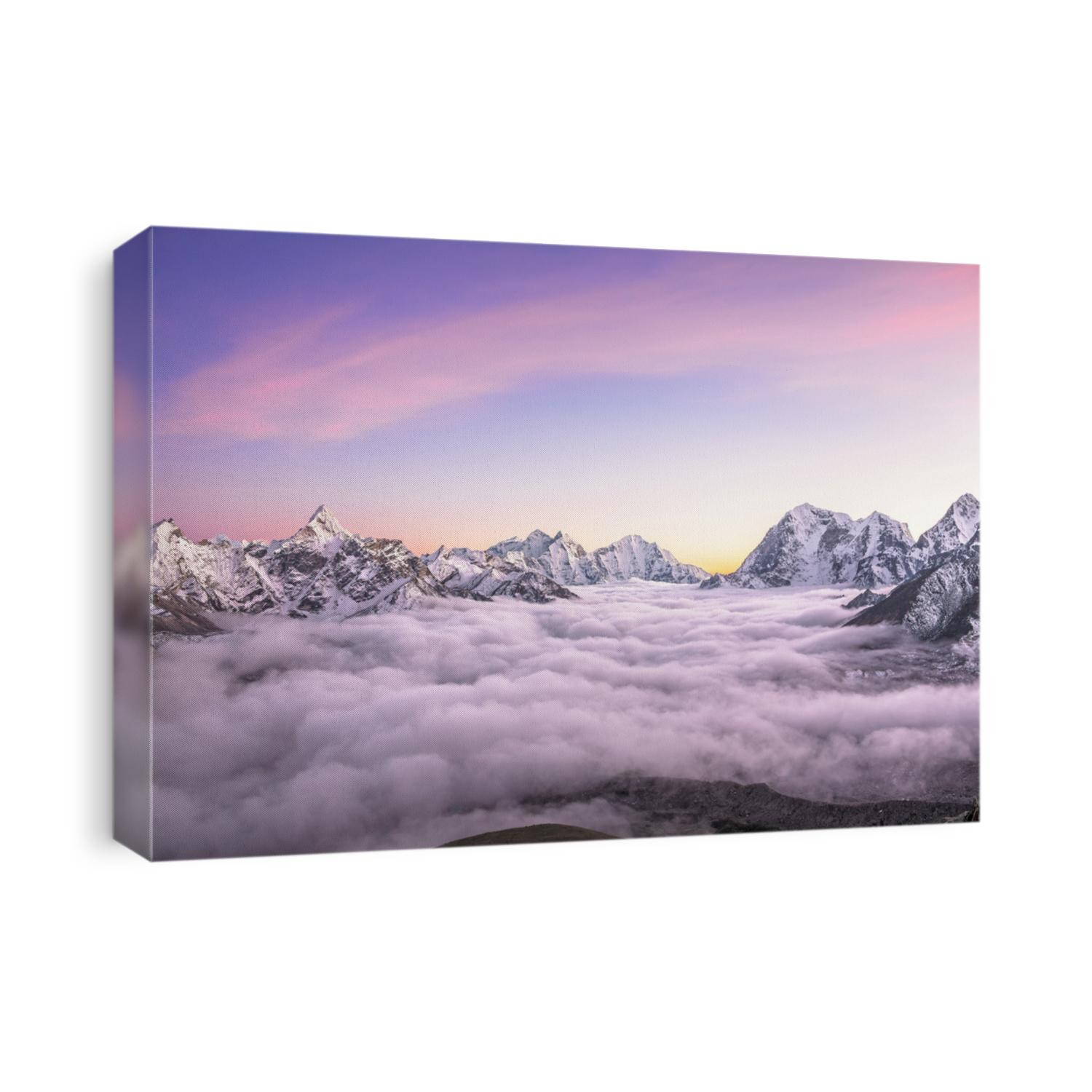 Picturesque mountain valley filled with curly clouds at sunset. Sacred Ama Dablam peak (6814 m) dominates on the left. Nepal, Himalayas. Canon 5D Mk II. 