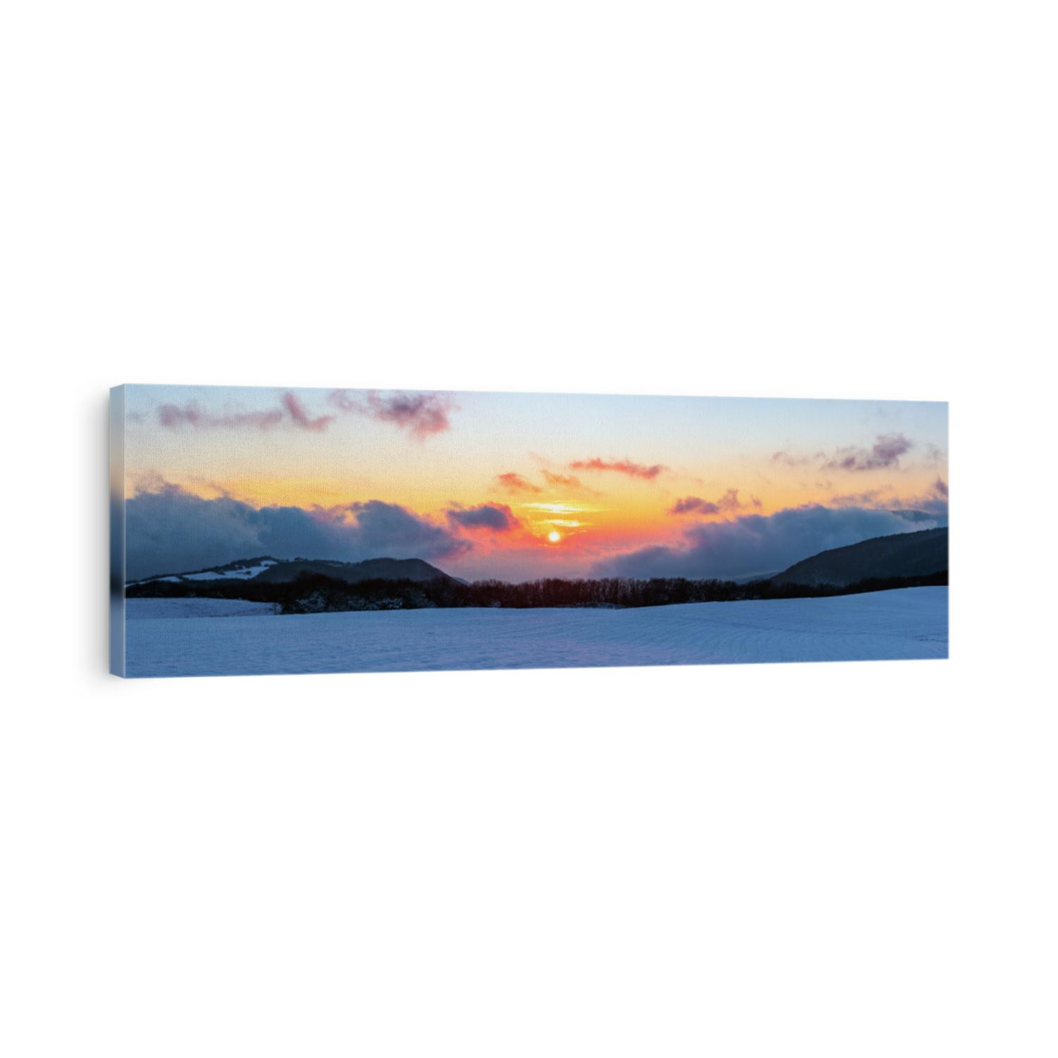 Panoramic view to beautiful vibrant winter sunset in the mountains