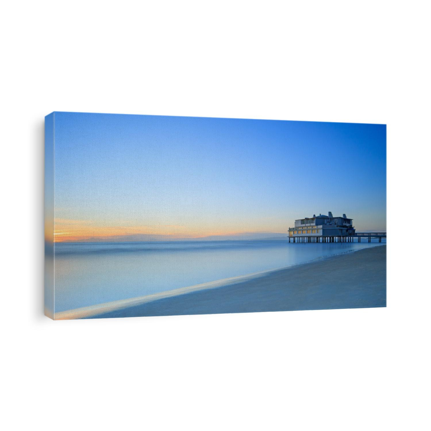 Pier and building on sea water and beach. Panoramic long exposure photography in Follonica travel destination, Maremma, Tuscany, Italy, Europe
