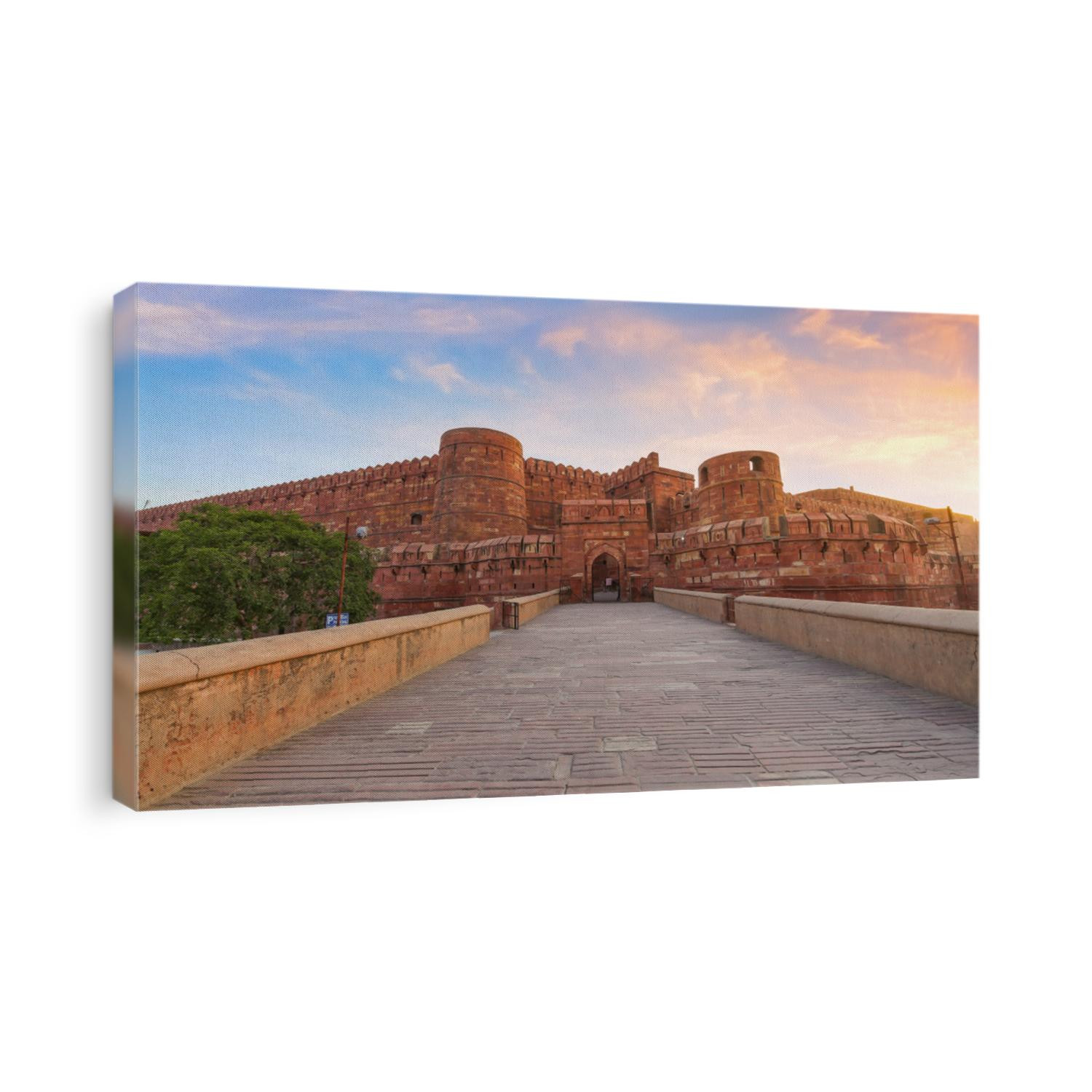 Agra Fort red sandstone medieval fort in panoramic view at sunrise. Agra Fort is a UNESCO World Heritage site in the city of Agra India.