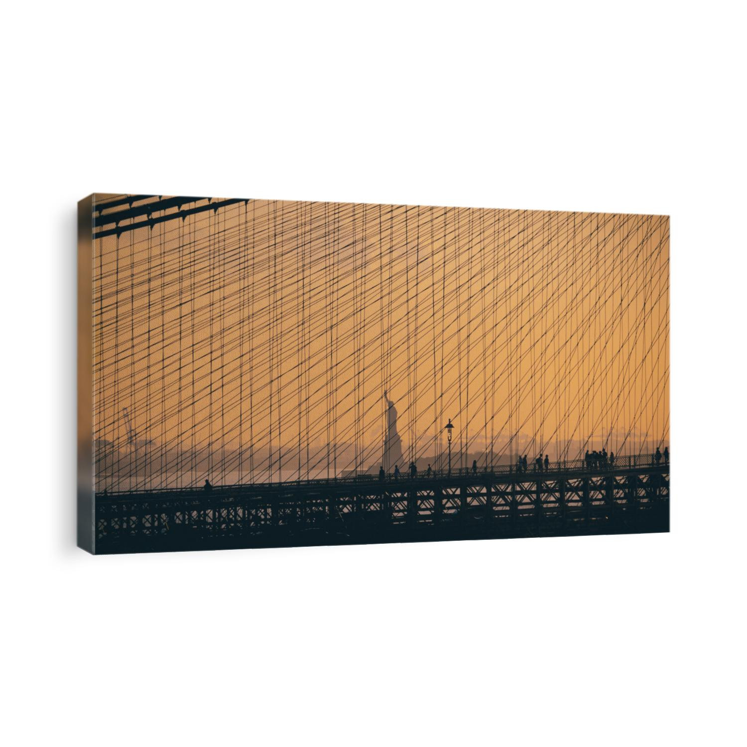 statue of liberty as seen though the Brooklyn Bridge