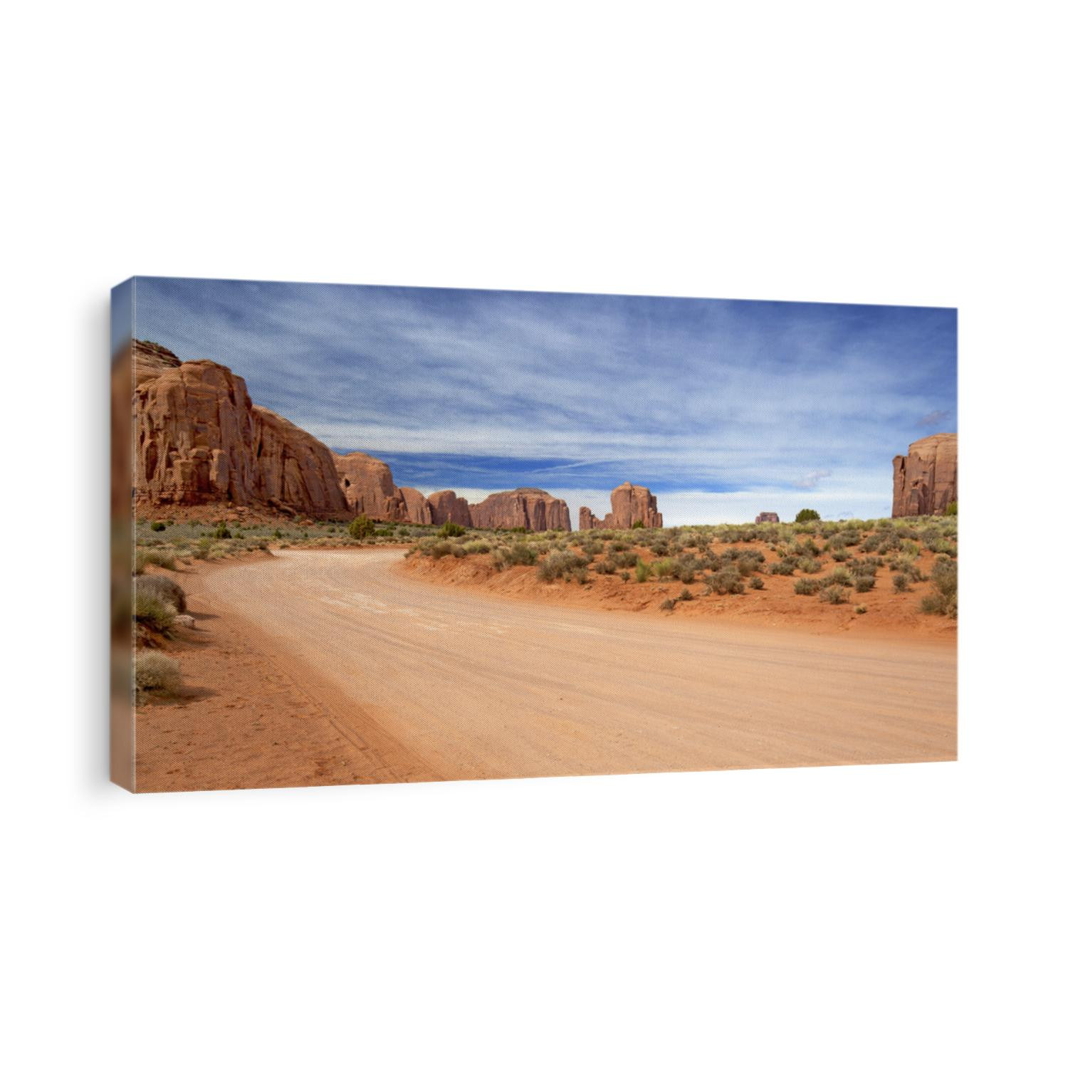 scenic and empty dirt road in monument valley
