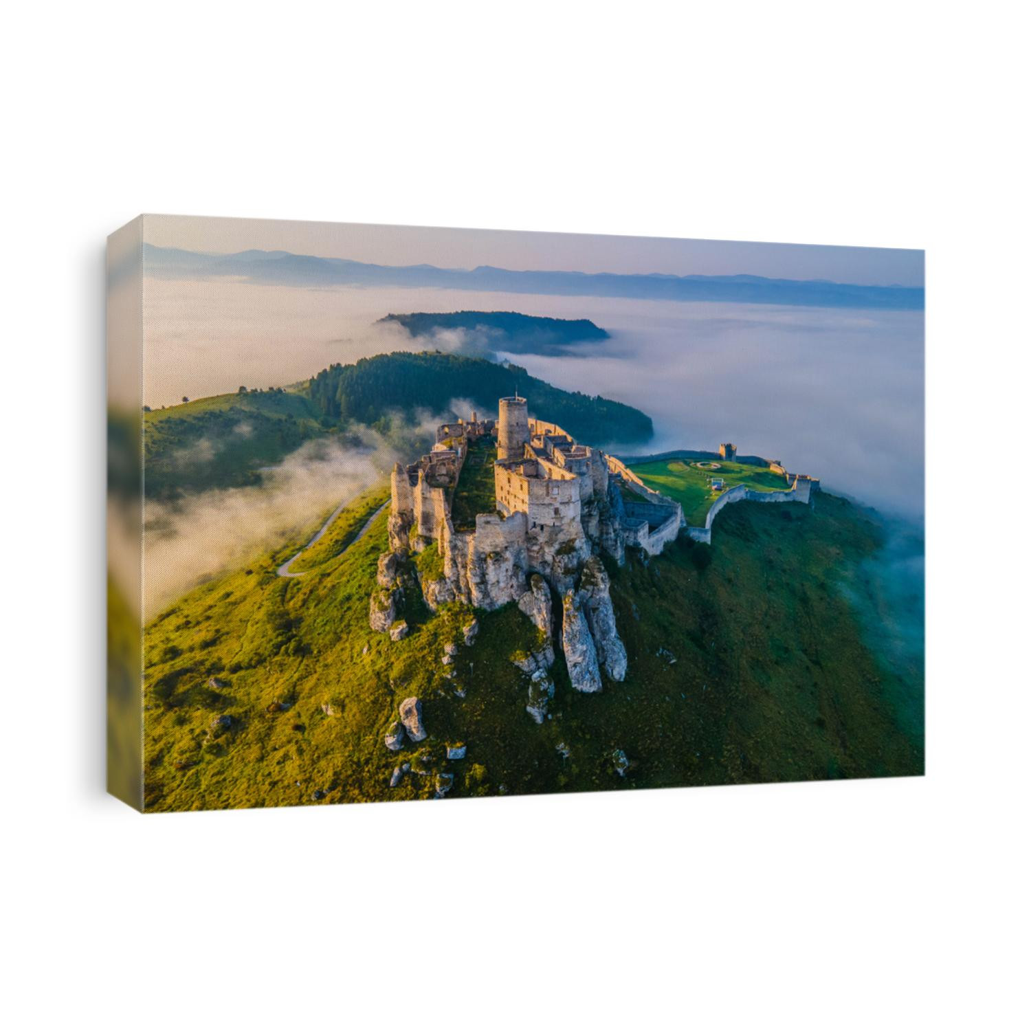 Aerial panoramic view of the Spiš Castle, Slovakia, in the morning sunlight with foggy background