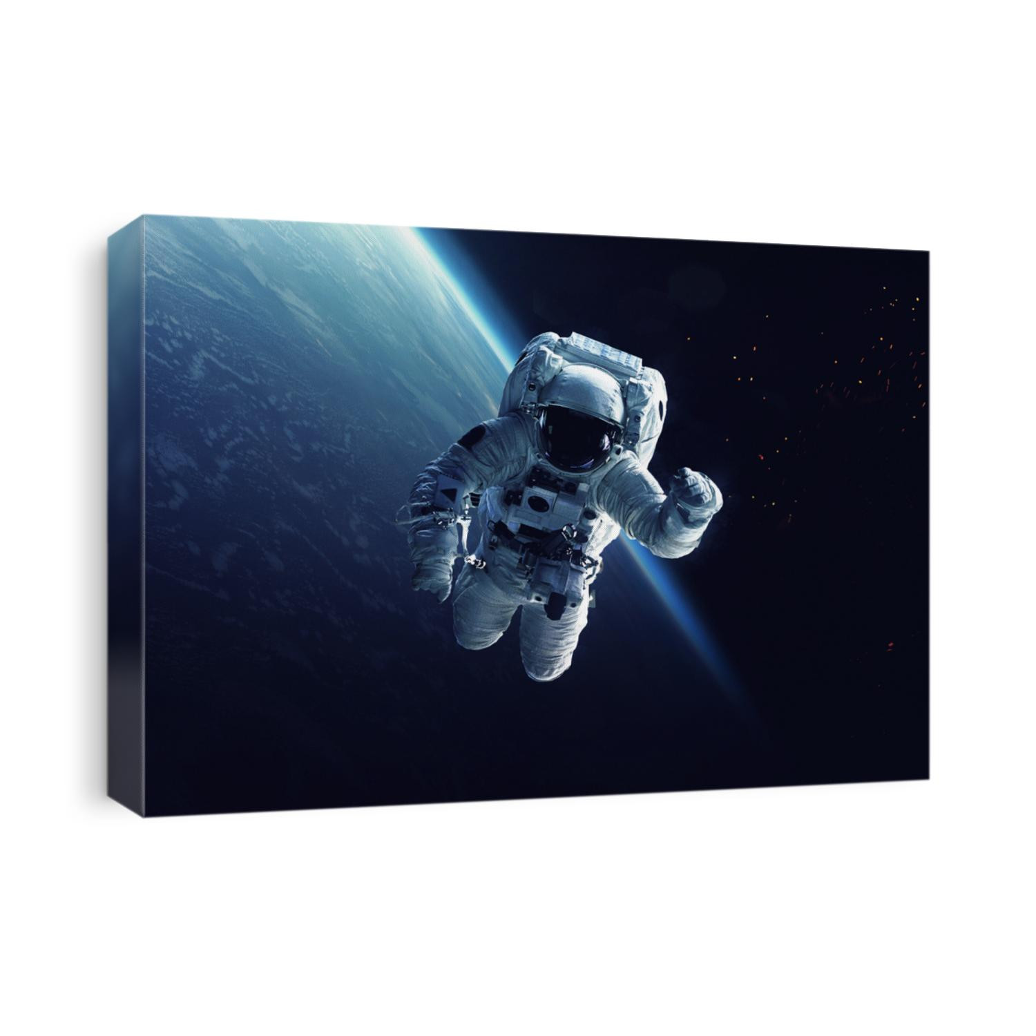 Astronaut at spacewalk. Cosmic art, science fiction wallpaper. Beauty of deep space. Billions of galaxies in the universe. Elements of this image furnished by NASA