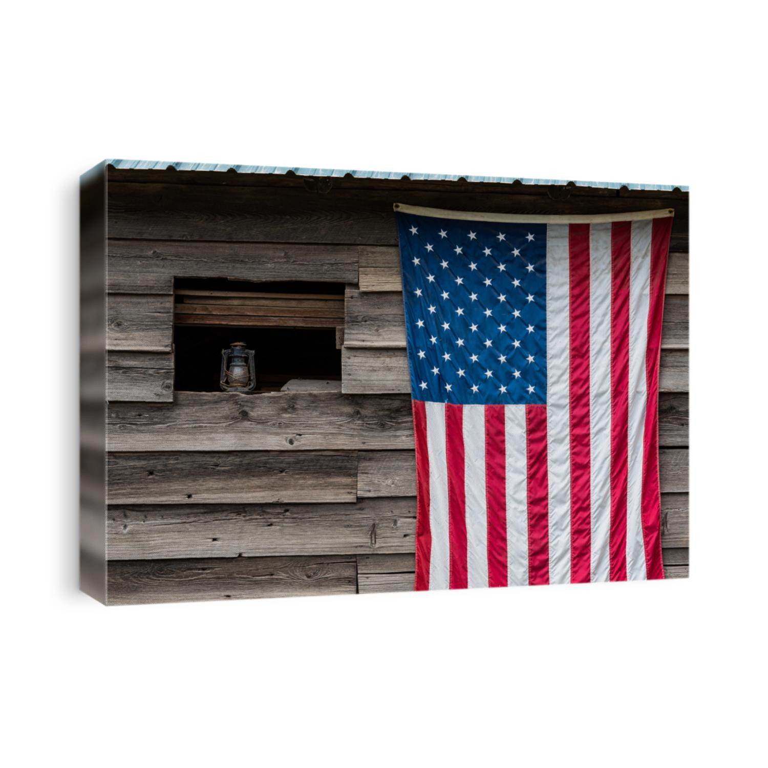 Rustic outside wall of wood building with green metal roof, open window with dusty lantern on windowsill, American flag hanging on wall
